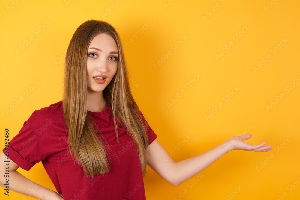Beautiful Young beautiful caucasian girl wearing red t-shirt over isolated yellow background feeling happy and cheerful, smiling and welcoming you, inviting you in with a friendly gesture Beautiful Young beautiful caucasian girl wearing red t-shirt over isolated yellow background feeling happy and cheerful, smiling and welcoming you, inviting you in with a friendly gesture