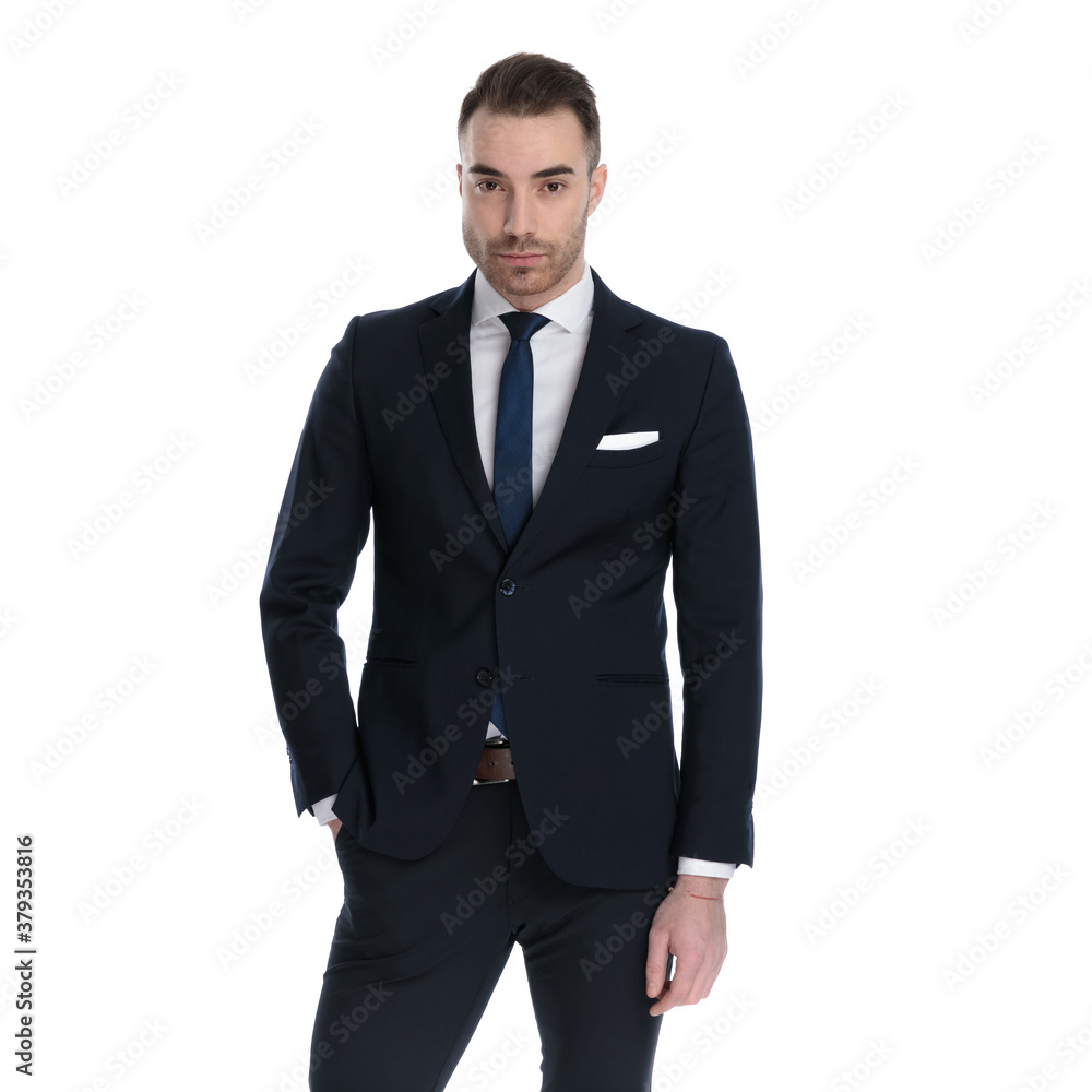 Unimpressed businessman looking forward with hand in pocket Unimpressed businessman looking forward with hand in pocket