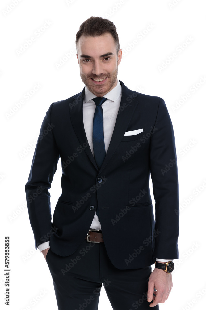 Confident businessman smiling with hand in pocket while standing Confident businessman smiling with hand in pocket while standing