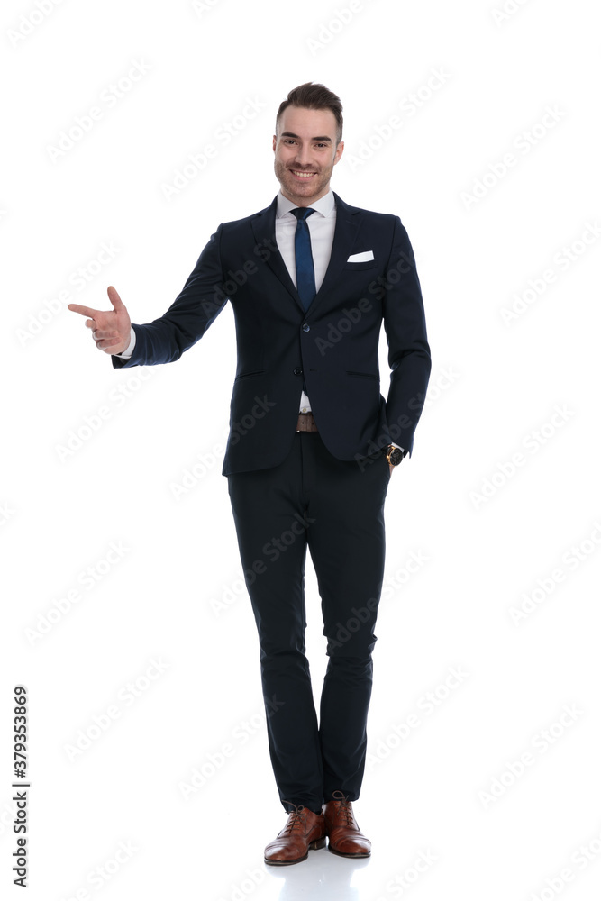 Happy businessman smiling and pointing away Happy businessman smiling and pointing away