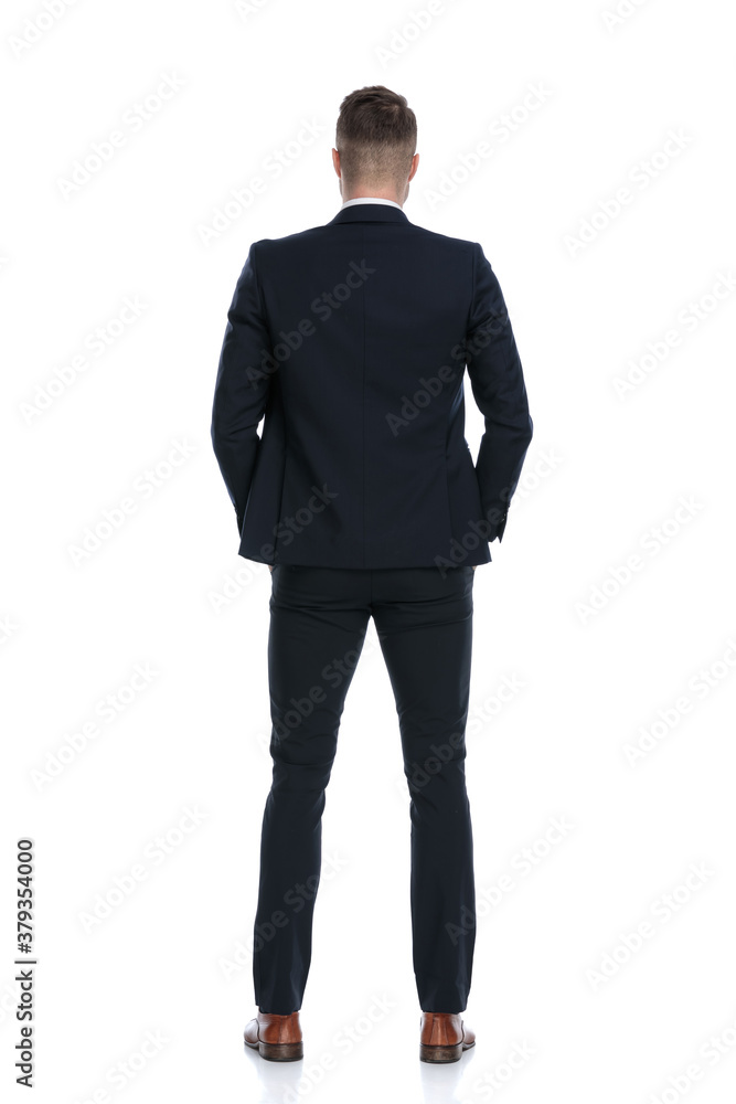 Back view of confident businessman holding hands in pockets Back view of confident businessman holding hands in pockets