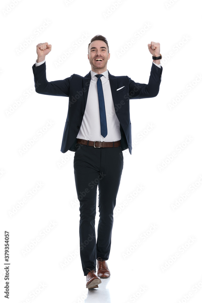 Happy businessman celebrating, shouting with both fists in the air