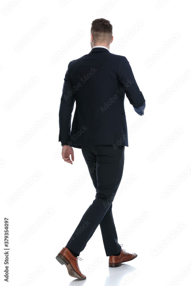 Side rear view of confident wearing suit and stepping Side rear view of confident wearing suit and stepping