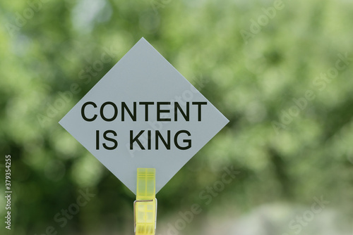 Content is King - text on card with green blur background