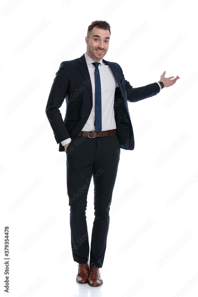 Happy businessman presenting with hand in pocket, smiling Happy businessman presenting with hand in pocket, smiling