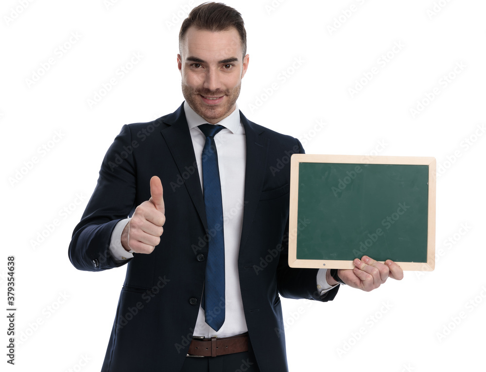 Positive businessman holding blackboard and giving thumbs up Positive businessman holding blackboard and giving thumbs up