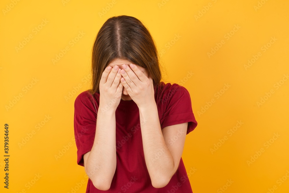 Young business man over isolated yellow background covering her face with her hands, being devastated and crying. Sad concept Young business man over isolated yellow background covering her face with her hands, being devastated and crying. Sad concept