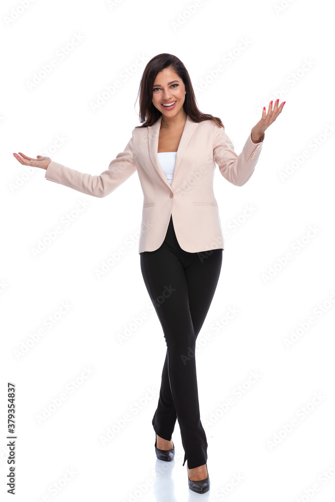 Beautiful businesswoman presenting and smiling while walking Beautiful businesswoman presenting and smiling while walking