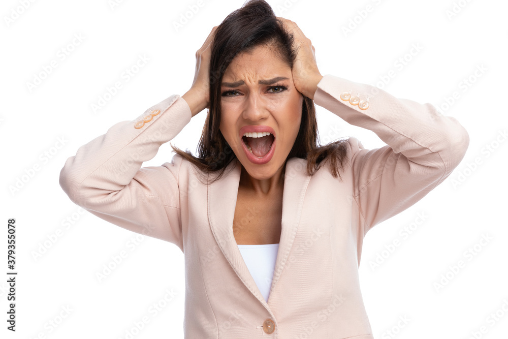 Closeup of scared businesswoman screaming with hands on head Closeup of scared businesswoman screaming with hands on head
