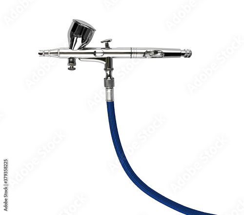 Fotografie professional chrome metal airbrush acrylic color paint spray gun tool with blue hose isolated white background