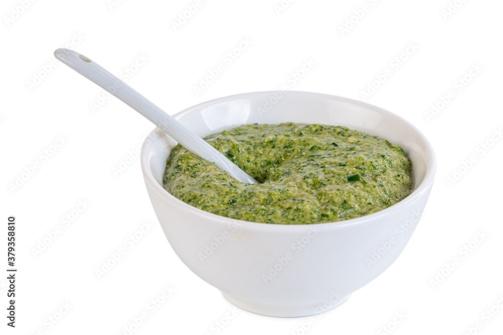Green sauce in the ceramic bowl isolated on white background. Adjika Green sauce in the ceramic bowl isolated on white background. Adjika