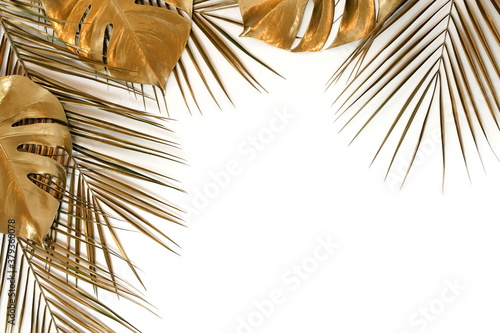 Gold leaf isolated on a white background top view. Golden monstera and palm leaves frame with copy space. abstract poster.