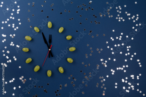 Sticker Clock of 12 piece grapes on blue background