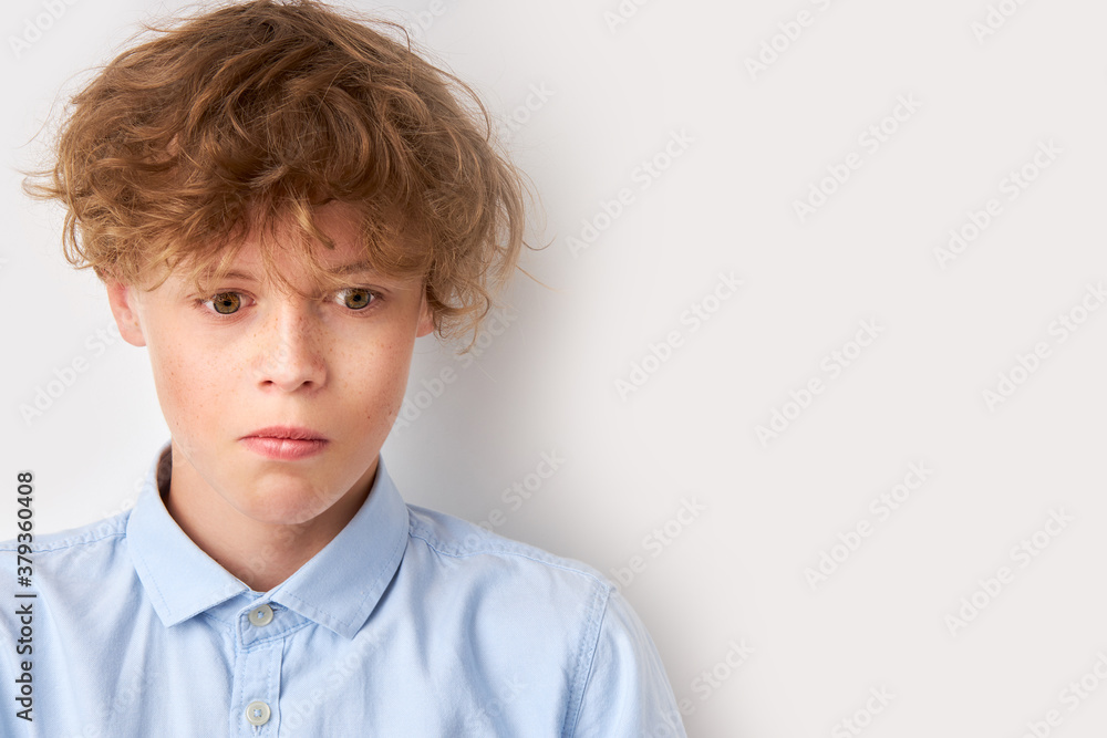 caucasian boy did something, now he doesn't know what to do. stand at a loss, isolated over white background caucasian boy did something, now he doesn't know what to do. stand at a loss, isolated over white background