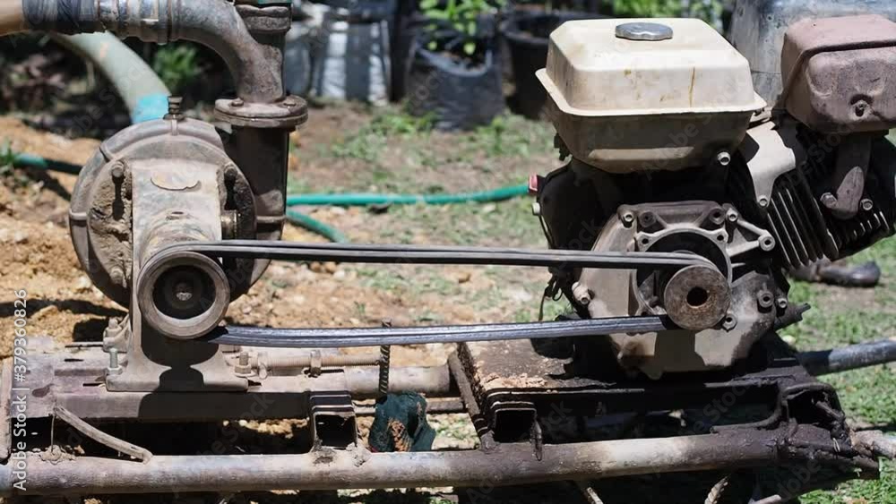 Close-up of pumping machine for groundwater drainage system pumps water out of the ground. Solve the drought. Slow motion Close-up of pumping machine for groundwater drainage system pumps water out of the ground. Solve the drought. Slow motion
