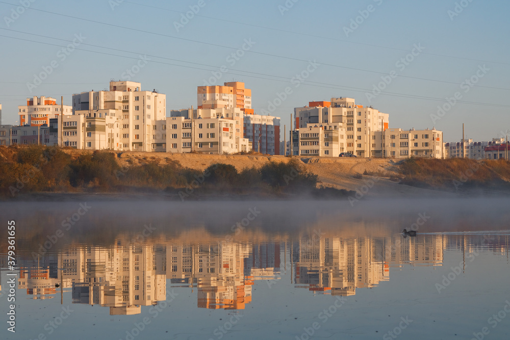 Multi-storey city houses near a lake with fog Gomel, BELARUS