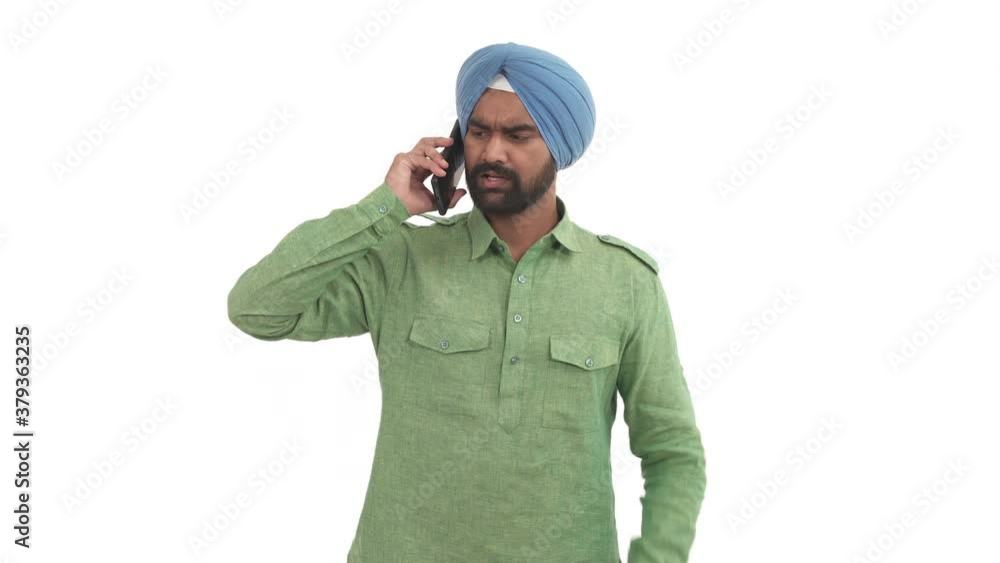 Indian beard man picks up smart phone and having heavy talk. Guy emotionally gesticulating, swearing with someone. Isolated on white background Indian beard man picks up smart phone and having heavy talk. Guy emotionally gesticulating, swearing with someone. Isolated on white background