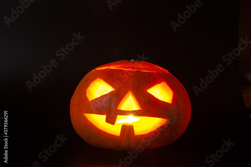 Halloween pumpkin head jack lantern on dark background
