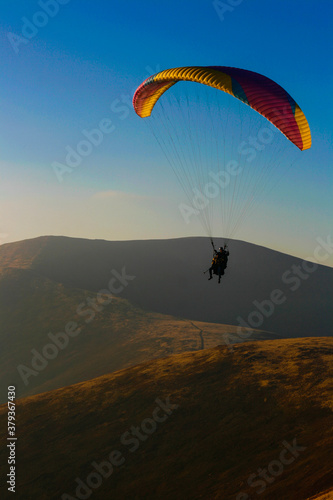 paraglider over the autumn mountains