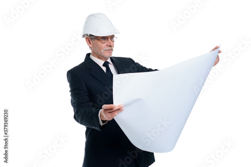 Older business man, civil engineer and designer wear a white safety helmet with project paper isolated on white background © Тарас Нагирняк