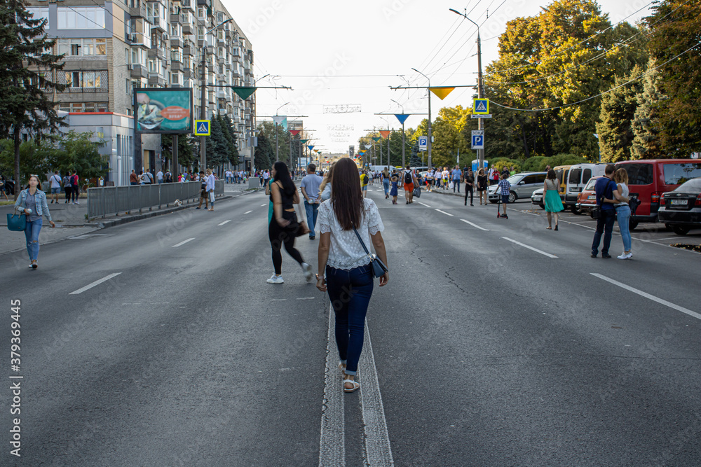 Beautiful young woman walking on the street