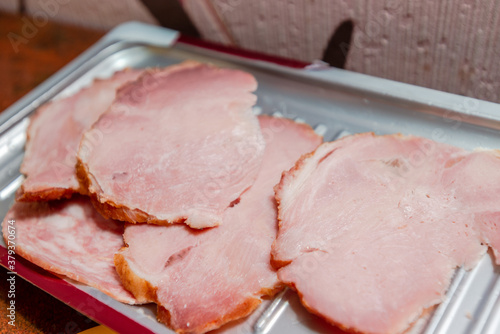 Top view of tasty sliced ham on grey table