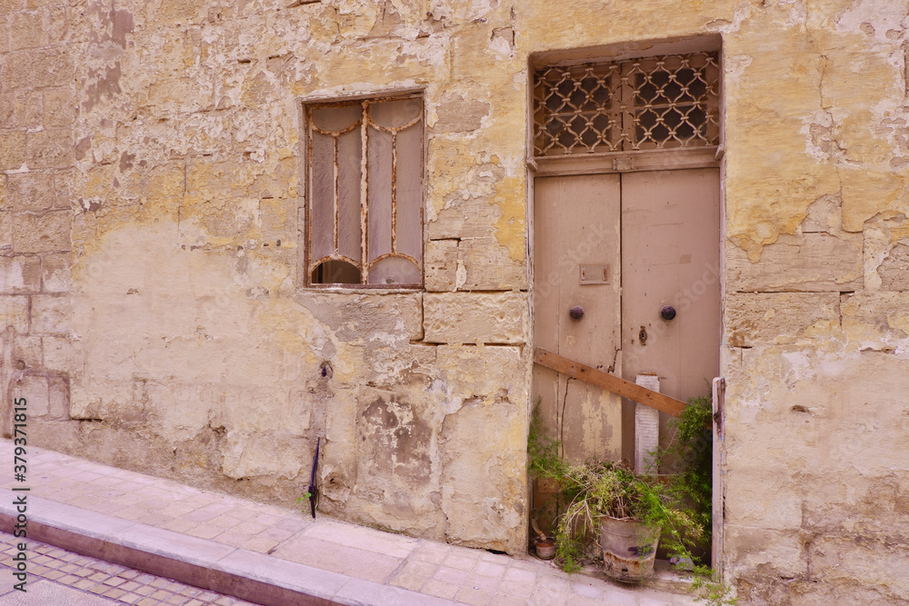 Doors and window to abandoned house with shabby wall Doors and window to abandoned house with shabby wall