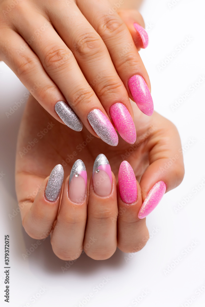 Shiny manicure on sharp long nails. Gel manicure. Pink silver French manicure with crystals. Shiny manicure on sharp long nails. Gel manicure. Pink silver French manicure with crystals.