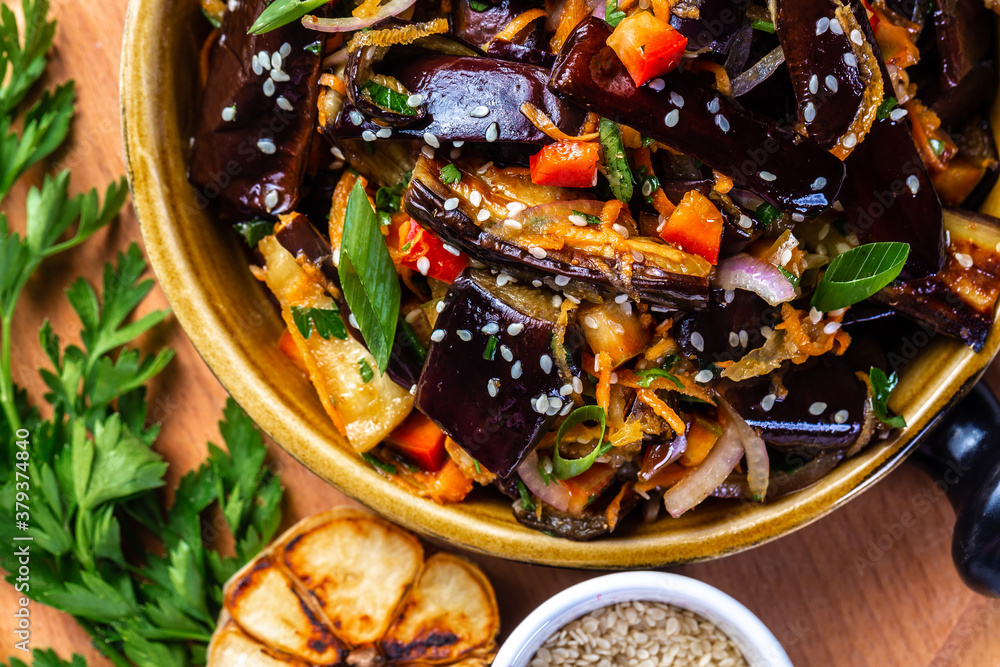 Baked eggplant salad with paprika, carrot, onion, garlic in Korean, Vegan food, Food recipe background. top view Baked eggplant salad with paprika, carrot, onion, garlic in Korean, Vegan food, Food recipe background. top view