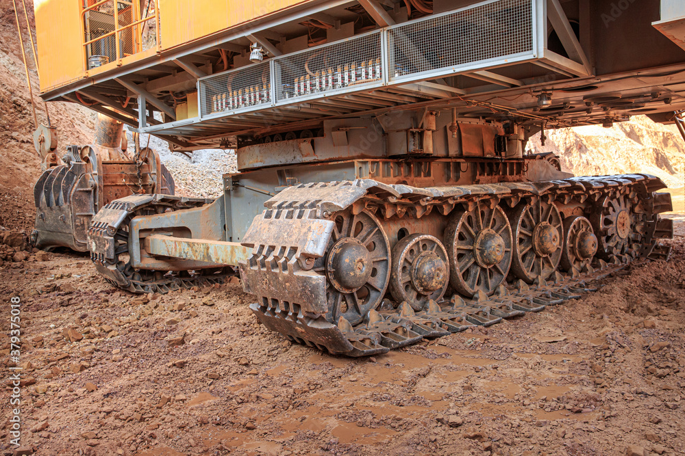 Crawler tracks of a large excavator in clay soil