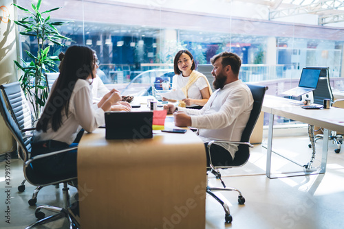 Group of colleagues listening to executive manager in workplace