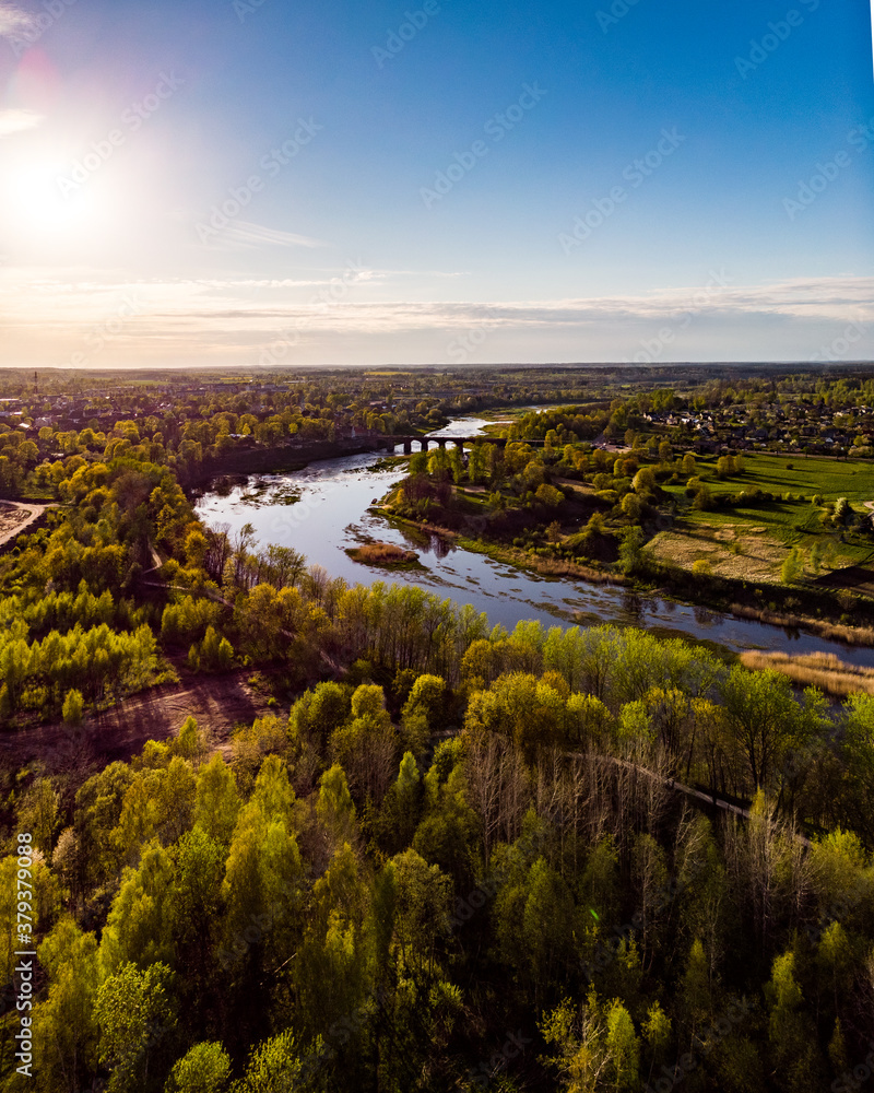 Areal countryside view from drone with small river Venta.