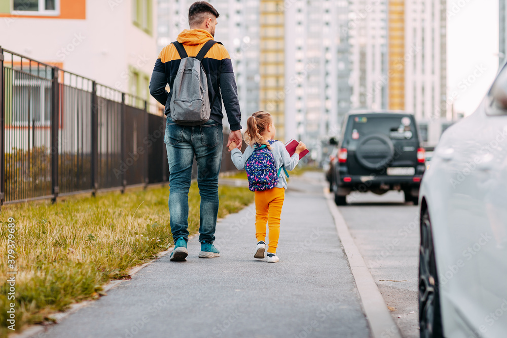 Father and daughter going to school for the first time. Back to school after pandemic.