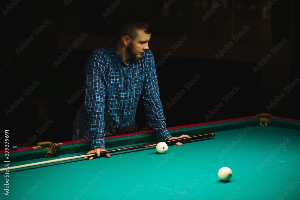 Fototapeta premium Playing billiard - Close-up shot of a man playing billiard