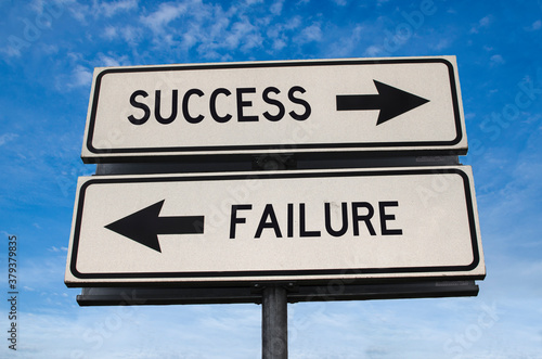 Success vs failure. White two street signs with arrow on metal pole with word. Directional road. Crossroads Road Sign, Two Arrow. Blue sky background. Two way road sign with text.