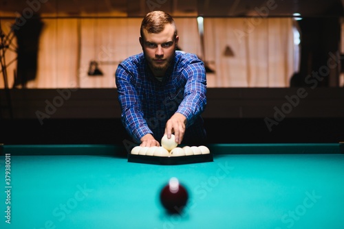 Obraz na plátně Playing billiard - Close-up shot of a man playing billiard
