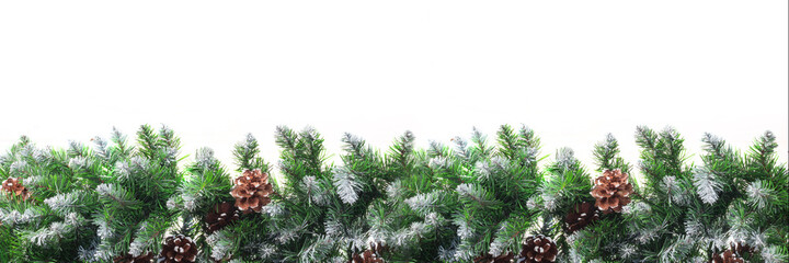Christmas frame with snow-covered branches of fir-pine, with cones, isolated on white background. Christmas and New Year concept. Copy space