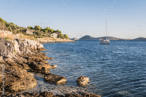 Rocky Adriatic coast near the fishing village at sunset in Croatia photo