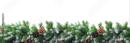 Christmas frame with snow-covered branches of fir-pine  with cones  isolated on white background. Christmas and New Year concept. Copy space