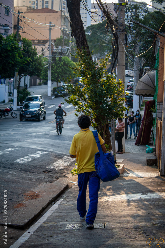 Mailman walking on a street in São Paulo, Brazil
