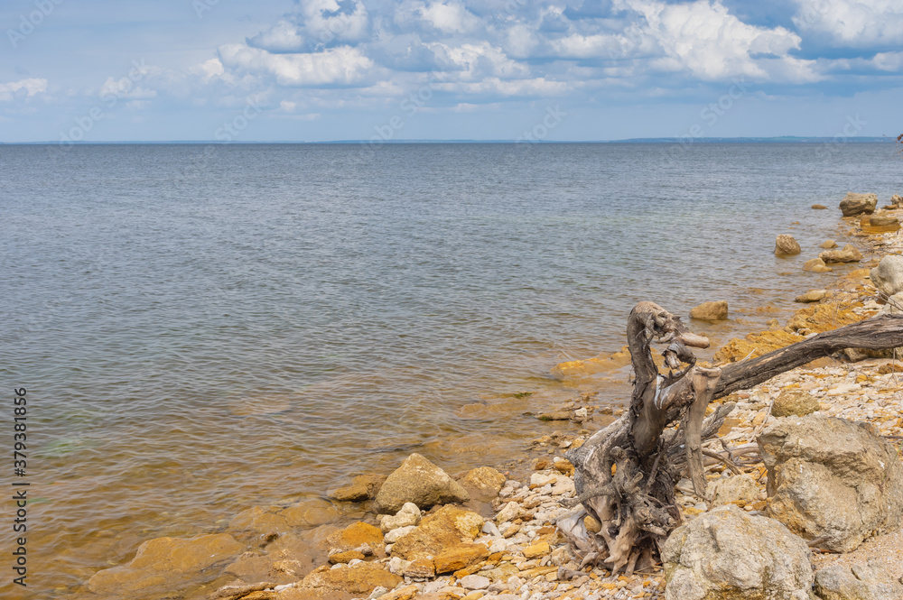 Spring landscape with wild pebble beach on Kakhovka Reservoir located on the Dnipro River