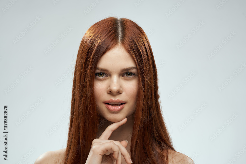 Woman with beautiful long hair care nude shoulders cosmetics cropped view light background Woman with beautiful long hair care nude shoulders cosmetics cropped view light background