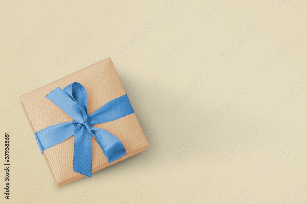 Gift box with ribbon on a rough background. Place for text Gift box with ribbon on a rough background. Place for text