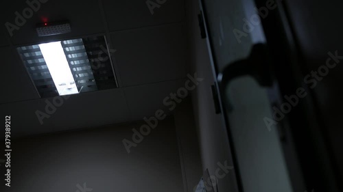 The fluorescent lamp turns on and starts to flicker, creating a scary picture