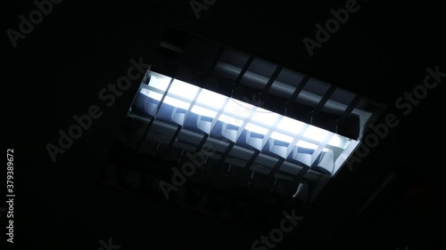 The fluorescent lamp turns on and starts to flicker, creating a scary picture