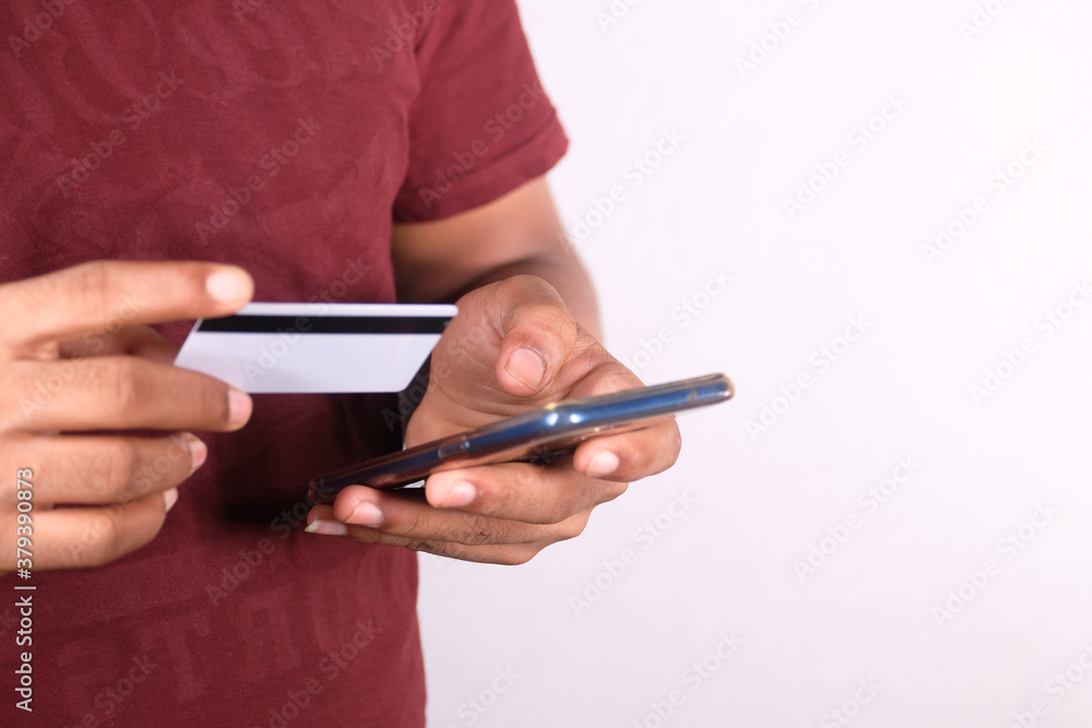 Man hand holding credit card and using smart phone shopping online Man hand holding credit card and using smart phone shopping online