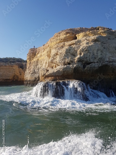 Postcard in which the ocean crashes on the rock