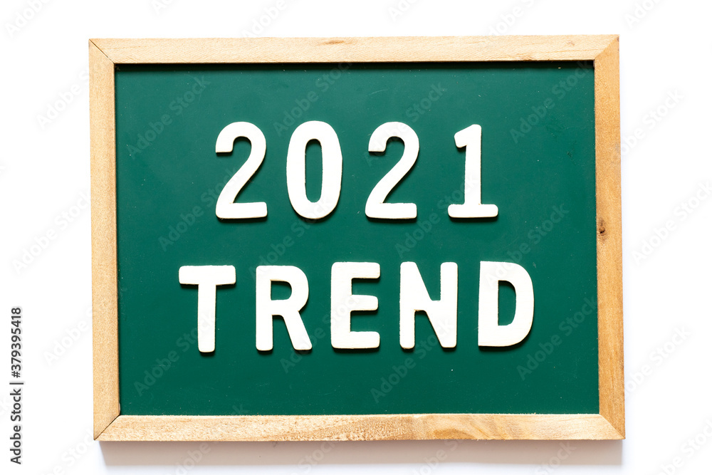 Fototapeta premium Green blackboard and wood frame with word 2021 trend on white background