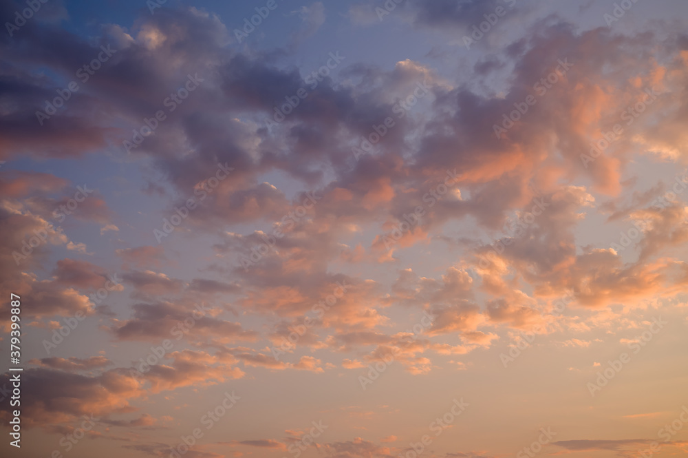 Dramatic sunset sky with colored clouds. Toned image.