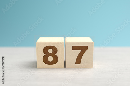 Wooden toy blocks forming the number 87. photo